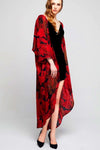Model wearing long black crepe kimono with red leaf prints